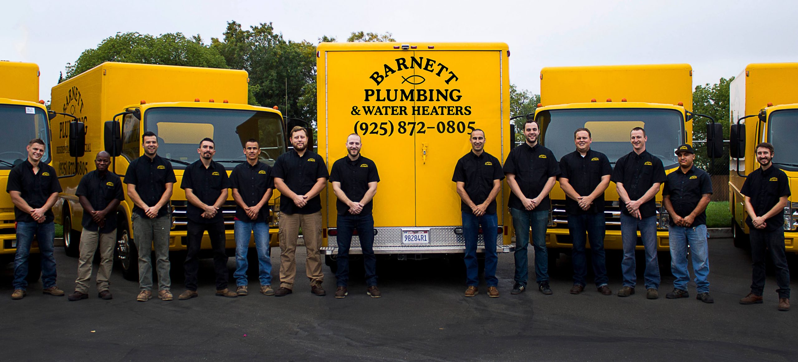 barnett-plumbing-family-in-front-of-trucks The Barnett Plumbing and Water Heaters team with work vehicles